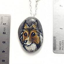 Load image into Gallery viewer, the rough collie portrait stone necklace, next to two rulers to show its size: about 1 1/4&quot; x 1 1/8&quot; or 3.2 cm x 2.8 cm across
