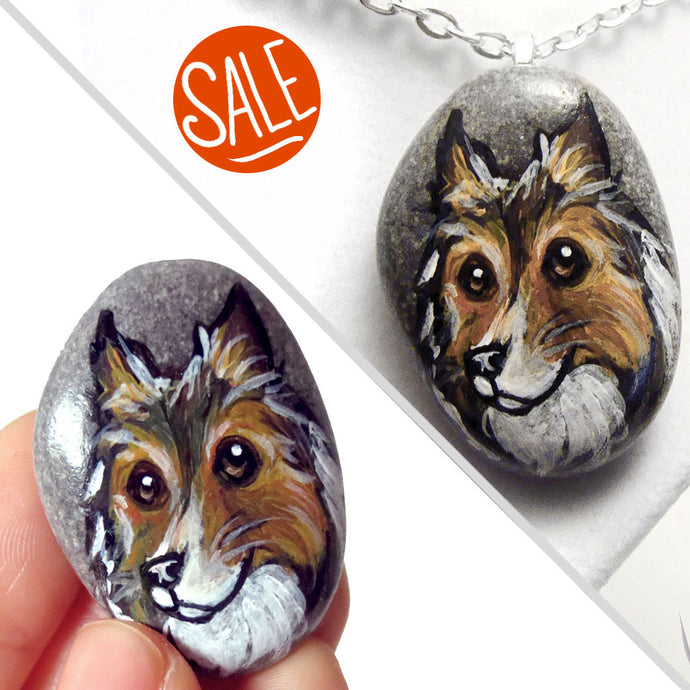 a beach rock painted with dog art: a portrait of a rough collie, available as either a keepsake or a pendant necklace