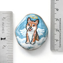 Load image into Gallery viewer, a smooth beach stone, hand painted with a portrait of a shiba inu dog as an angel, sitting on clouds against a light blue sky. available as a keepsake or pendant necklace.
