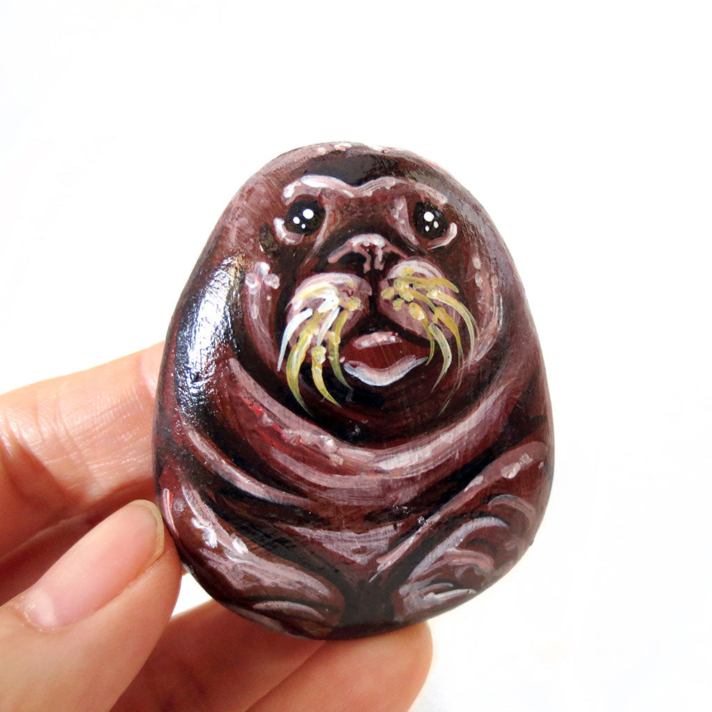 wade the walrus is hand painted on a small beach rock