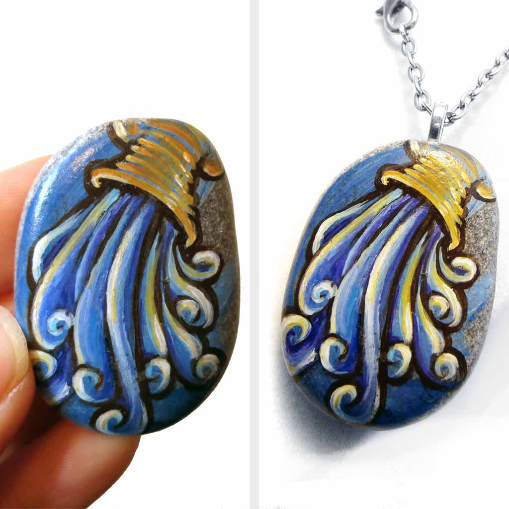 a beach stone hand painted with the symbol of Aquarius: the water bearer. available as a rock art keepsake or pendant necklace