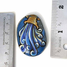 Load image into Gallery viewer, a beach stone hand painted with the symbol of Aquarius: the water bearer. available as a rock art keepsake or pendant necklace
