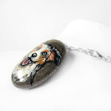Load image into Gallery viewer, A dog portrait necklace, painted on a beach stone, of an Australian Shepherd dog
