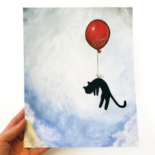 Load image into Gallery viewer, an art print with an illustration of a silhouette of a black cat, attached by the waiste to a big red balloon, as it floats through a blue cloudy sky
