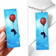 Load image into Gallery viewer, a wood rectangle hand painted with art of a black dachshund dog, with a red balloon, floating through a blue sky. available as a keepsake or pendant necklace
