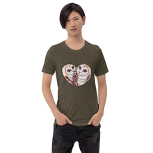 Load image into Gallery viewer, A man wearing the Barn Owl Love Premium Unisex  T-Shirt in army brown, includes art of two barn owls forming the shape of a heart.
