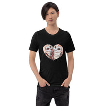 Load image into Gallery viewer, A man wearing the Barn Owl Love Premium Unisex  T-Shirt in black heather, includes art of two barn owls forming the shape of a heart.
