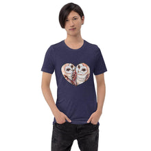 Load image into Gallery viewer, A man wearing the Barn Owl Love Premium Unisex  T-Shirt in midnight navy blue, includes art of two barn owls forming the shape of a heart.
