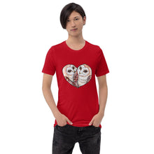 Load image into Gallery viewer, A man wearing the Barn Owl Love Premium Unisex T-Shirt in red, includes art of two barn owls forming the shape of a heart.
