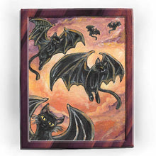 Load image into Gallery viewer, This art print features 5 black cats with giant bat wings, soaring through the cloudy orange sky
