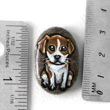 Load image into Gallery viewer, a small beach stone, hand painted with a portrait of a beagle puppy. available as a keepsake rock art or pendant necklace
