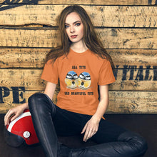 Load image into Gallery viewer, A woman wearing the Beautiful Tits Premium Unisex T-shirt in burnt orange, with art of two blue tit birds, and the words, &quot;all tits are beautiful tits&quot;
