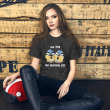 Load image into Gallery viewer, A woman wearing the Beautiful Tits Premium Unisex T-shirt in dark grey heather, with art of two blue tit birds, and the words, &quot;all tits are beautiful tits&quot;
