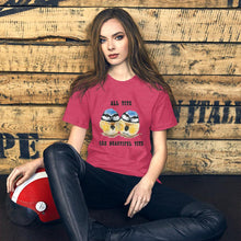 Load image into Gallery viewer, A woman wearing the Beautiful Tits Premium Unisex T-shirt in heather raspberry with art of two blue tit birds, and the words, &quot;all tits are beautiful tits&quot;
