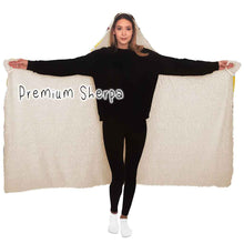 Load image into Gallery viewer, a woman wears the Beer Lovers Hooded Blanket, lined with premium sherpa: a white hooded blanket printed with a variety of different beer styles in different glasses
