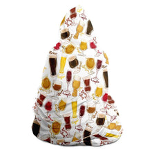 Load image into Gallery viewer, a woman wears the Beer Lovers Hooded Blanket: a white hooded blanket printed with a variety of different beer styles in different glasses
