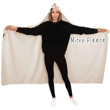 Load image into Gallery viewer, a woman wears the Beer Lovers Hooded Blanket, lined with microfiber fleece: a white hooded blanket printed with a variety of different beer styles in different glasses
