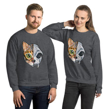 Load image into Gallery viewer, A man and woman are wearing a unisex sweatshirt in the colour dark heather grey, printed with a graphic split into two: the left side features the face of a bengal cat, and the right side features an evil looking cat skull.
