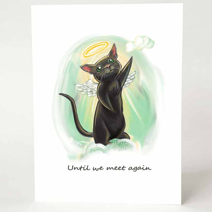 A greeting card with art of a black cat with green eyes, angel wings and a halo. it stands up on the clouds to reach a small cloud nearby. The card reads, 