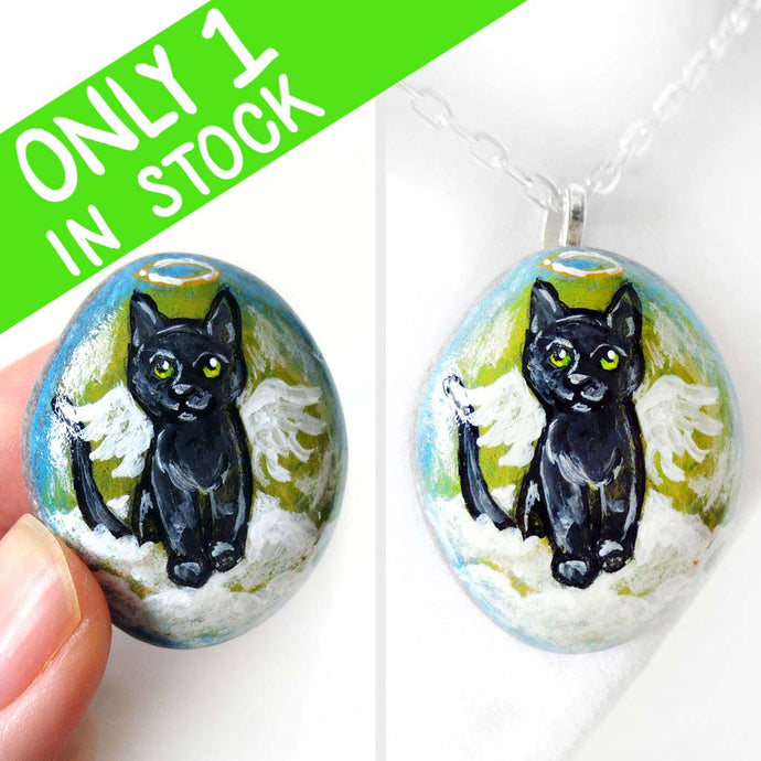 Rock art of a black cat as an angel, painted on a small beach stone, it's available alone or as a pendnat necklace.