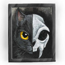 Load image into Gallery viewer, An art print split in half: the left side shows one side of a black cat&#39;s face, with a yellow eye, and the right side shows a stylized cat skull
