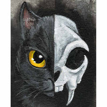 Load image into Gallery viewer, An art print split in half: the left side shows one side of a black cat&#39;s face, with a yellow eye, and the right side shows a stylized cat skull
