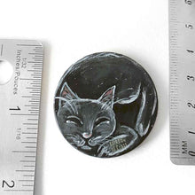 Load image into Gallery viewer, a wood circle, hand painted with a sleeping black cat, available as a keepsake or necklace pendant with chain.
