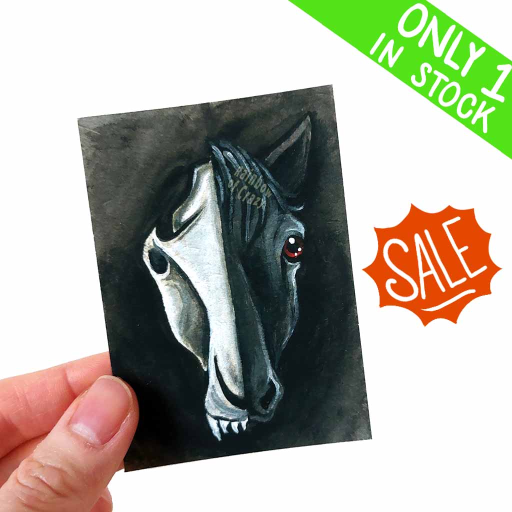 an aceo featuring a split portrait of a horse: a dark stylized horse skull on the left side and a black horse on the right