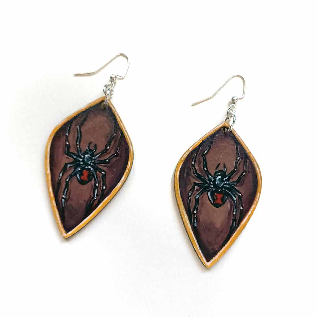 leaf shaped, wood fish hook earrings, hand painted with black widow spiders against a brown background, with a gold border