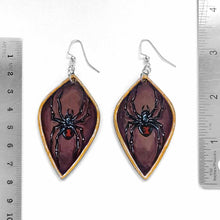 Load image into Gallery viewer, leaf shaped, wood fish hook earrings, hand painted with black widow spiders against a brown background, with a gold border
