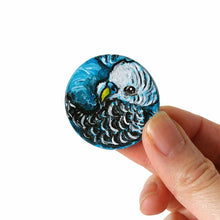 Load image into Gallery viewer, a small wood circle, hand painted with the portrait of a blue budgie bird, available as a keepsake or pendant necklace
