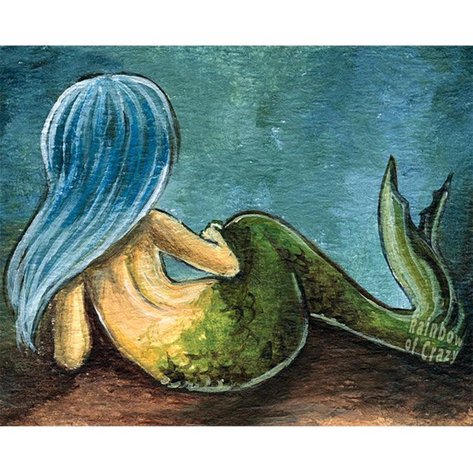 An art print of a mermaid with ice blue hair, lying down on the ocean floor, facing away.