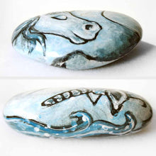 Load image into Gallery viewer, small rock art hand painted with the portrait of a light blue unicorn with its eyes closed
