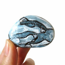 Load image into Gallery viewer, the underside of a small rock art of a blue unicorn, showing its legs, signed with, Rainbow Crazy
