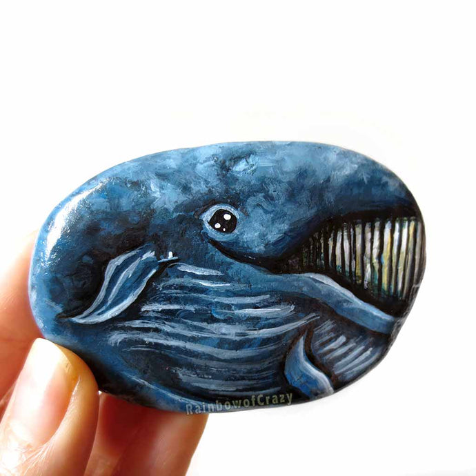 rock art portrait of a smiling blue whale