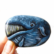 Load image into Gallery viewer, rock art portrait of a smiling blue whalea flat rock, hand painted with a portrait of a smiling blue whale
