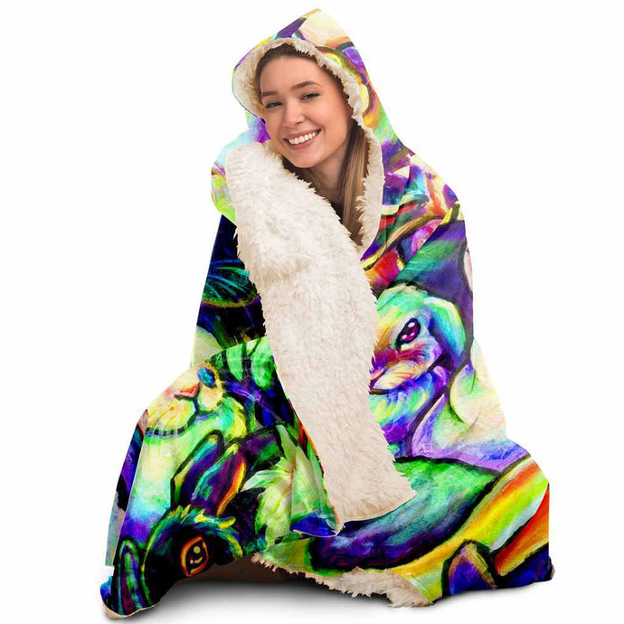 a woman wears the Bunny Lovers Rainbow Hooded Blanket, linked with sherpa