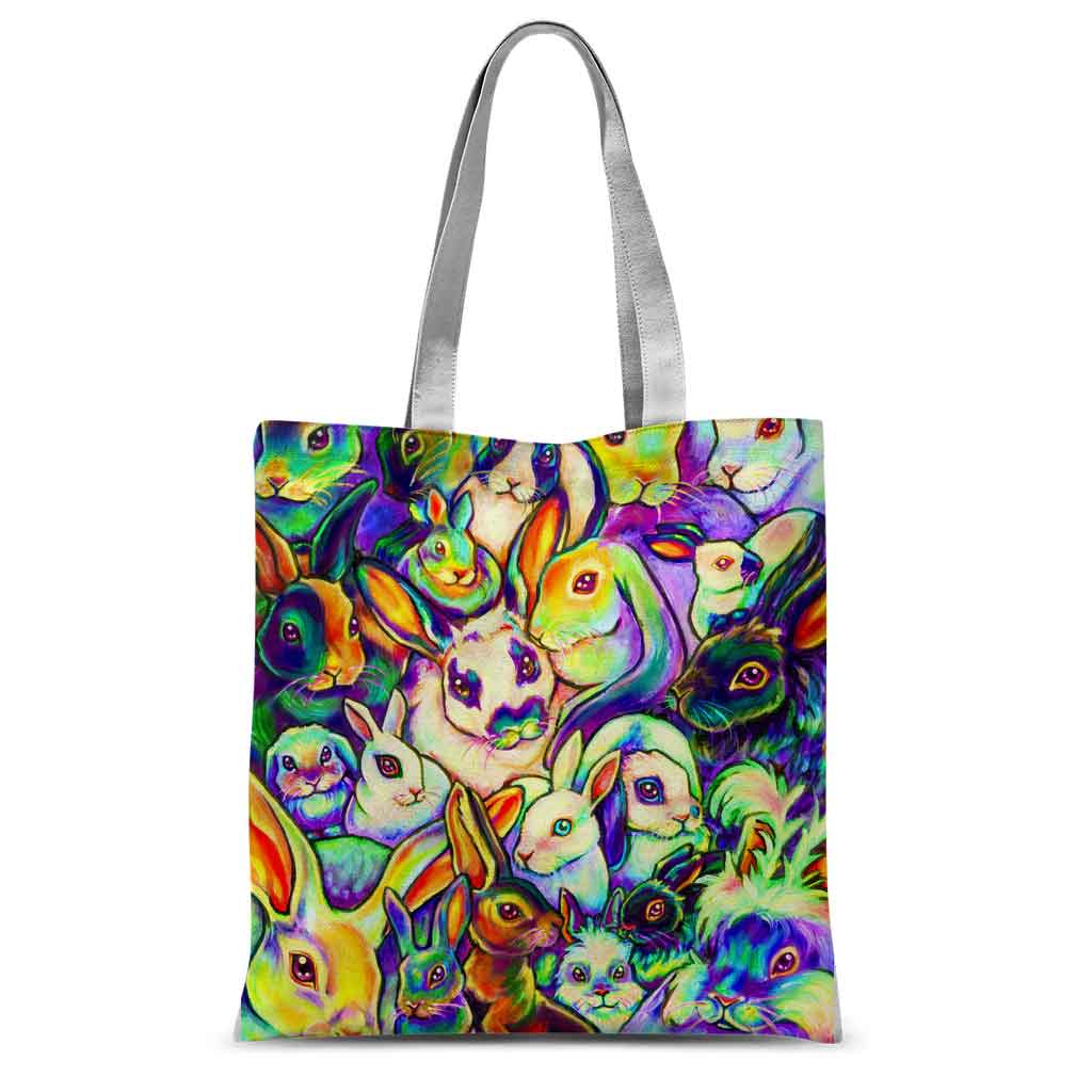 a tote bag, printed with an illustration of painted rabbits. different breeds are featured in rainbow colours