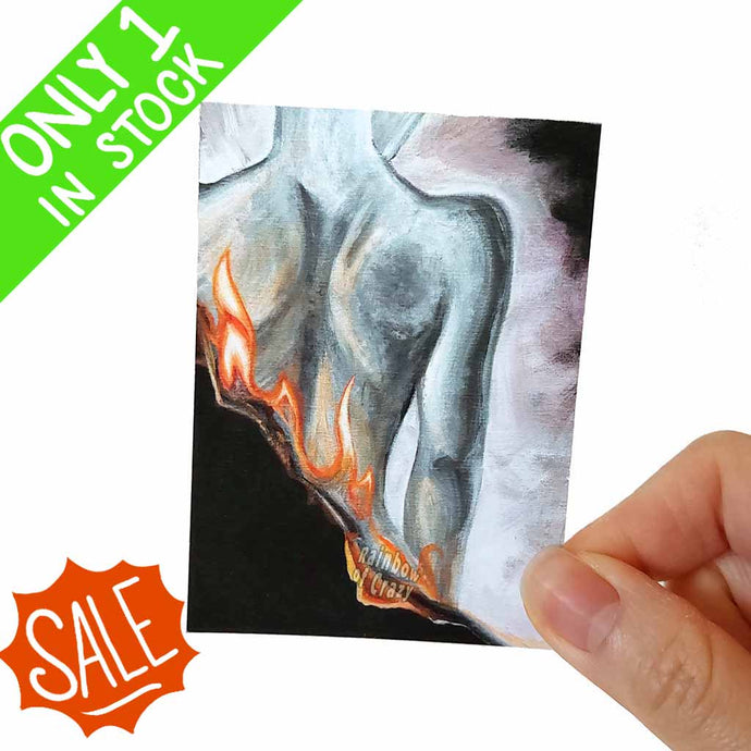 an aceo art print features a female back, while the image itself goes up in flames