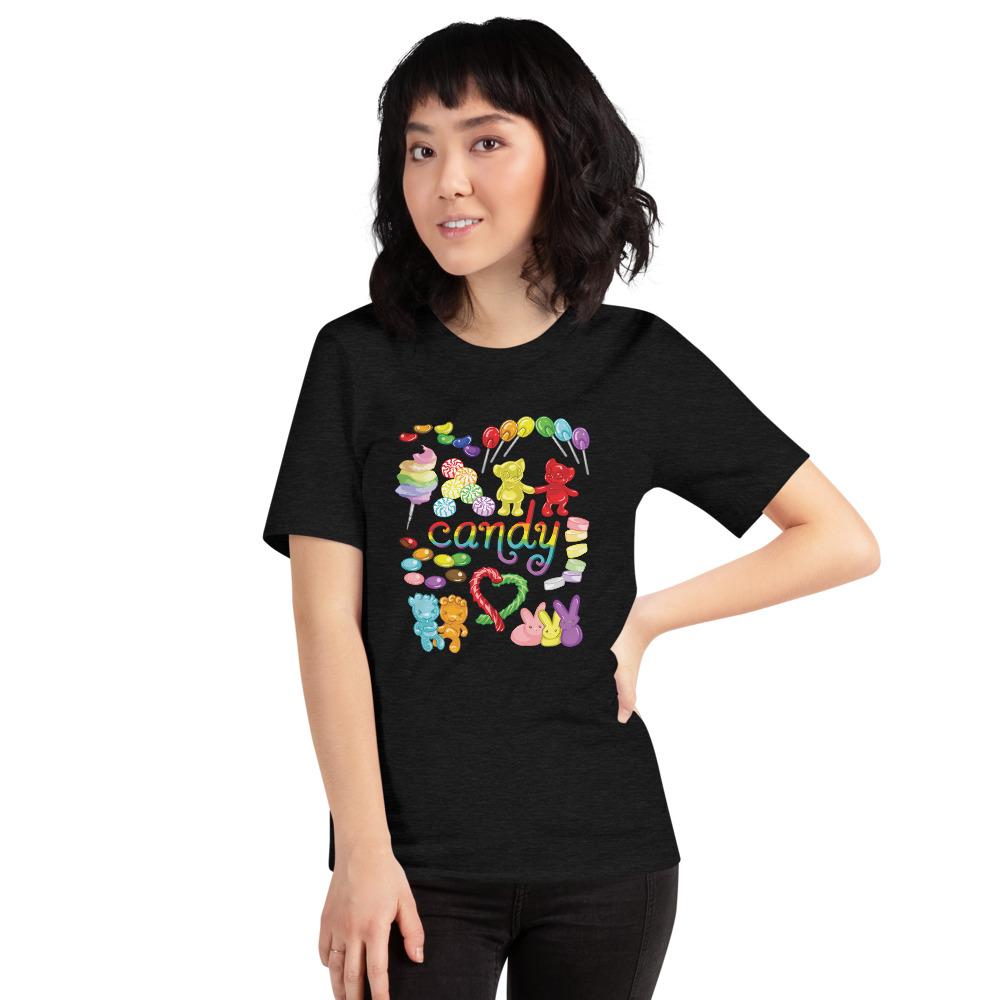 A woman wearing the Candy Lovers Premium Unisex T-shirt in black heather, which includes an illustration of 10 types of rainbow candy