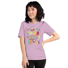 Load image into Gallery viewer, A woman wearing the Candy Lovers Premium Unisex T-shirt in heather prism ice lilac, which includes a graphic of 10 types of rainbow candy
