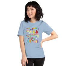 Load image into Gallery viewer, A woman wearing the Candy Lovers Premium Unisex T-shirt in light blue, which includes a graphic of 10 types of rainbow candy
