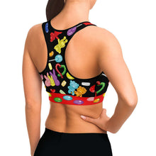 Load image into Gallery viewer, A woman wearing the Candy Lovers Sports Bra, featuring art of different rainbow candy.
