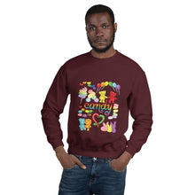 Load image into Gallery viewer, A man wearing the Candy Lovers Unisex Sweatshirt in the colour maroon. It features a graphic of ten different types of candy in rainbow colours
