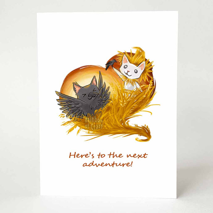 a greeting card features art of a white cat as a scarecrow, on a wheat field, holding a tiny crow, while a black cat dresses up as a crow and dances. the card reads, here's to the next adventure!