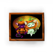 Load image into Gallery viewer, an art print featuring an illustration of a black cat and white cat looking very unimpressed in pumpkin costumes.
