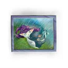 Load image into Gallery viewer, an art print featuring an illustration of a white cat wearing a purple witch hat, holding onto a scared black cat, while the hat protects them from the rain.
