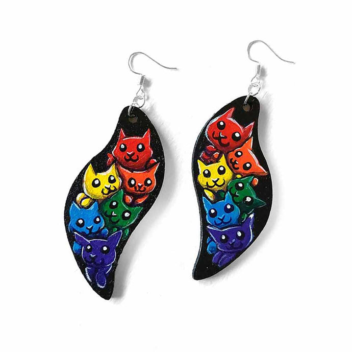 wavy leaf shaped wood earrings, hand painted with six different cartoon cats in every colour of the rainbow, with a black background