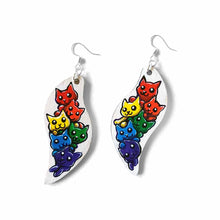 Load image into Gallery viewer, wavy, leaf shaped, wood earrings, hand painted with six cats in every colour of the rainbow, against a white background
