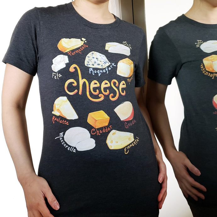A woman is wearing the Cheese Lovers Unisex Premium T-shirt in dark grey heather, which includes art of 10 styles of cheese.